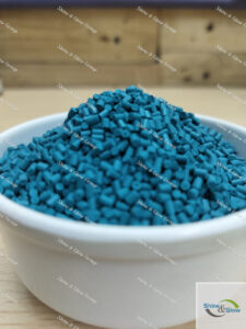 "An image showcasing a container filled with master batch granules in different vibrant colors, used for enhancing properties and appearance in manufacturing processes."




